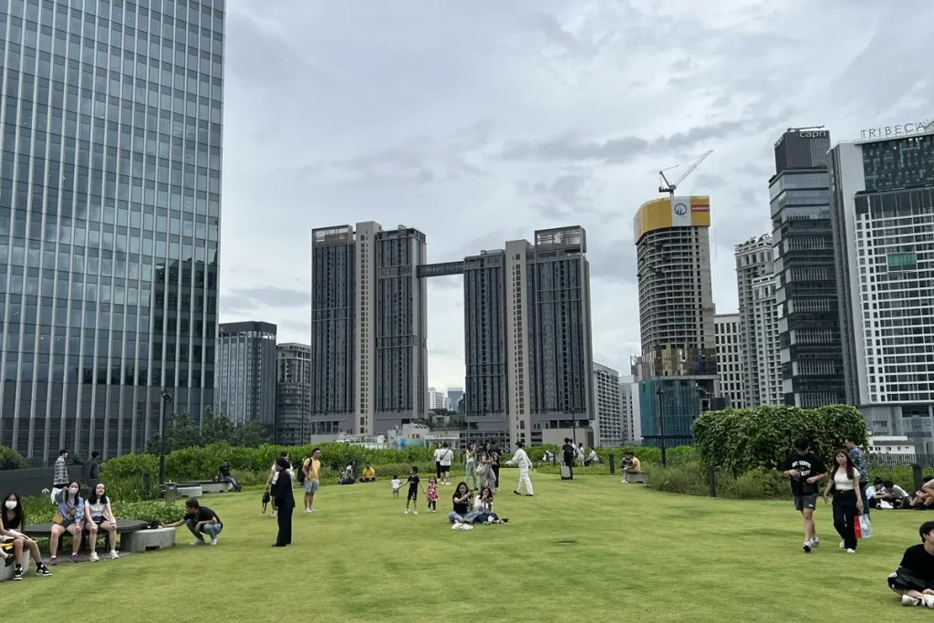 Modern city towers surrounding a landscaped public space